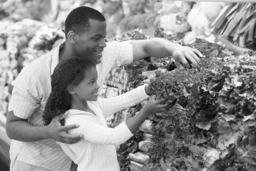 Man and child choosing produce.